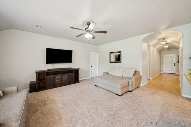 9246 N 143rd E Ave, Owasso, OK 74055 - carpeted living room featuring arched walkways, ceiling fan, and vaulted ceiling