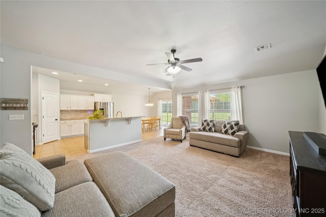 9246 N 143rd E Ave, Owasso, OK 74055 - living room featuring ceiling fan, recessed lighting, a chandelier, and light carpet