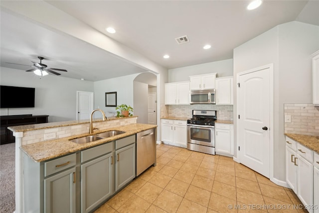 9246 N 143rd E Ave, Owasso, OK 74055 - kitchen with stainless steel appliances, tasteful backsplash, white cabinets, a center island with sink, and recessed lighting