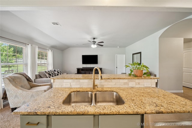 9246 N 143rd E Ave, Owasso, OK 74055 - kitchen featuring open floor plan, light stone counters, ceiling fan, and arched walkways