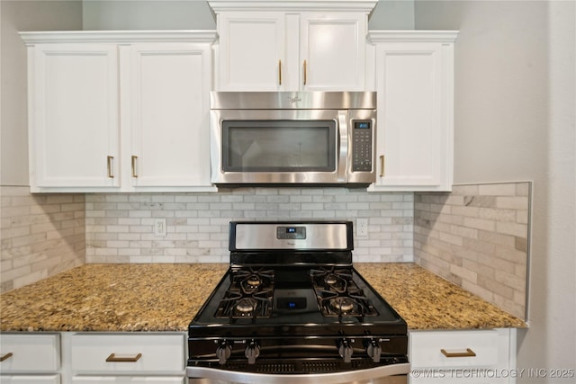 9246 N 143rd E Ave, Owasso, OK 74055 - kitchen featuring stainless steel appliances, white cabinetry, and light stone counters