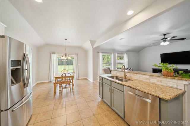 9246 N 143rd E Ave, Owasso, OK 74055 - kitchen featuring appliances with stainless steel finishes, gray cabinetry, vaulted ceiling, light tile patterned floors, and a chandelier