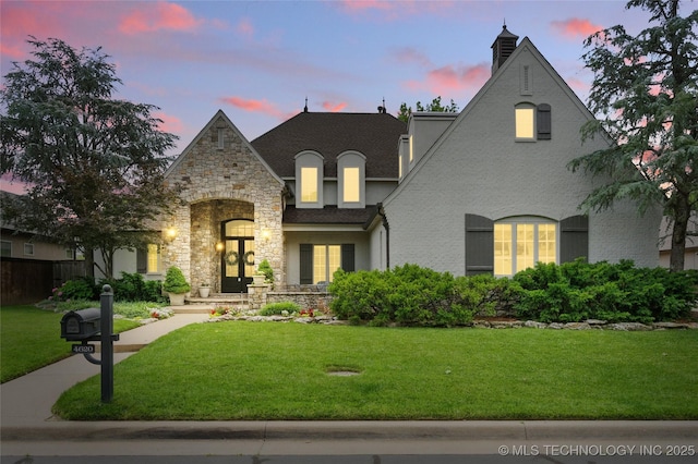4620 E 108th Pl S, Tulsa, OK 74137 - french country home featuring a yard, stone siding, and stucco siding