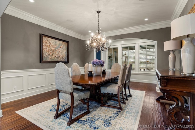 4620 E 108th Pl S, Tulsa, OK 74137 - dining room featuring arched walkways, wood finished floors, a chandelier, crown molding, and a wainscoted wall
