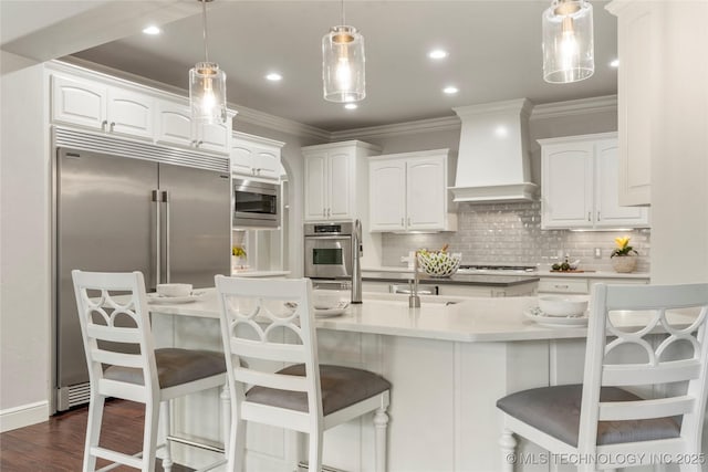 4620 E 108th Pl S, Tulsa, OK 74137 - kitchen with custom exhaust hood, built in appliances, crown molding, white cabinets, and decorative backsplash