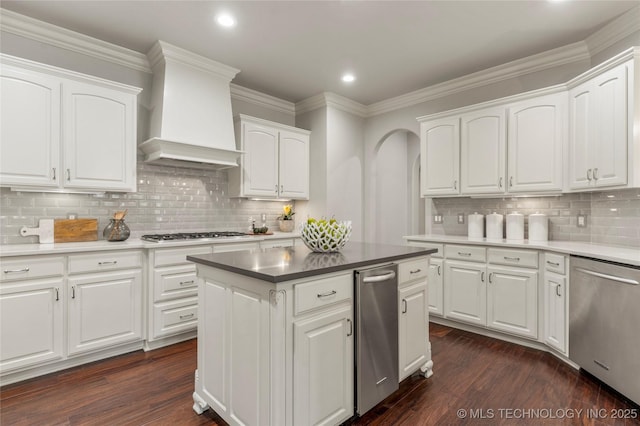 4620 E 108th Pl S, Tulsa, OK 74137 - kitchen with appliances with stainless steel finishes, dark wood-type flooring, tasteful backsplash, recessed lighting, and ornamental molding