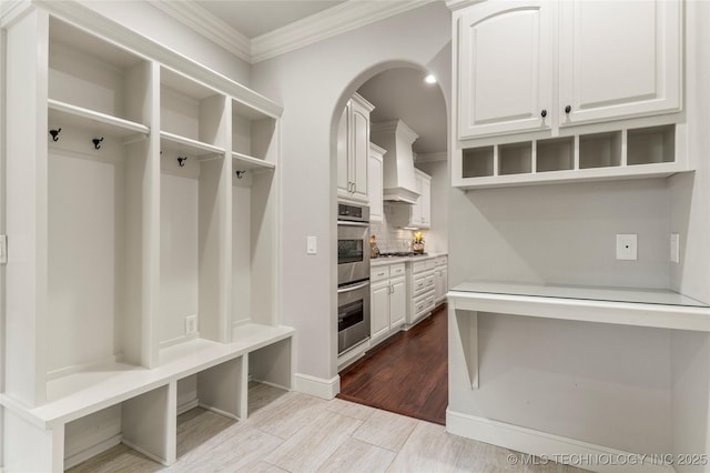 4620 E 108th Pl S, Tulsa, OK 74137 - mudroom featuring ornamental molding, wood finished floors, and arched walkways