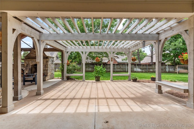 4620 E 108th Pl S, Tulsa, OK 74137 - fenced backyard featuring an outdoor stone fireplace, a pergola, and a patio