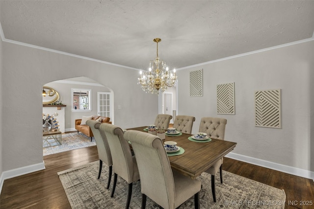 1743 S Florence Pl, Tulsa, OK 74104 - dining area with arched walkways, a chandelier, wood finished floors, ornamental molding, and a textured ceiling