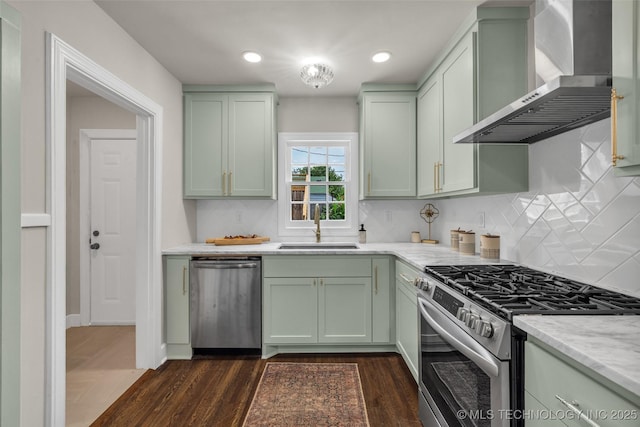 1743 S Florence Pl, Tulsa, OK 74104 - kitchen with stainless steel appliances, wall chimney exhaust hood, green cabinets, dark wood-type flooring, and decorative backsplash