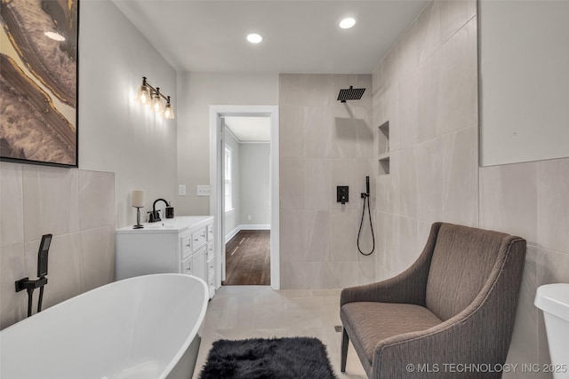 1743 S Florence Pl, Tulsa, OK 74104 - full bathroom with tile walls, a freestanding bath, tiled shower, vanity, and recessed lighting