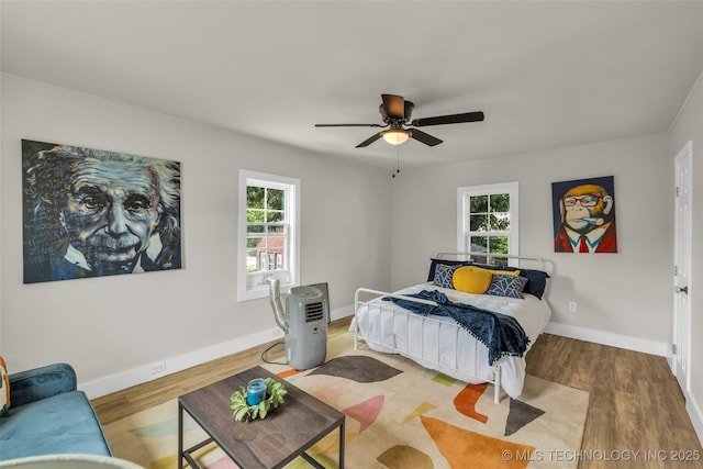 1743 S Florence Pl, Tulsa, OK 74104 - bedroom with multiple windows, wood finished floors, and ceiling fan