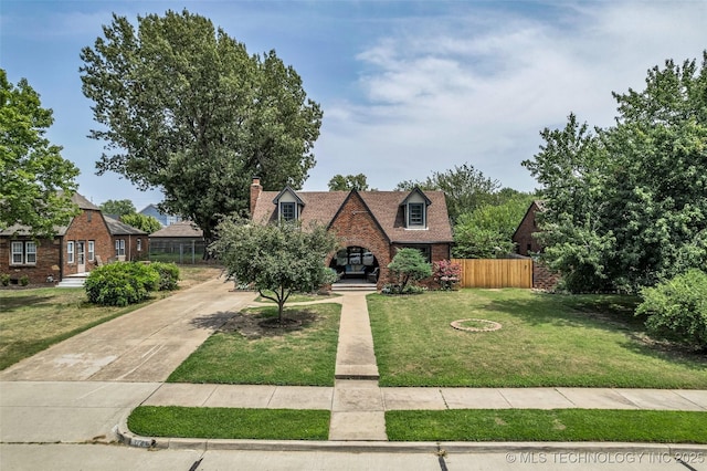 1743 S Florence Pl, Tulsa, OK 74104 - view of front facade featuring concrete driveway, brick siding, and a chimney