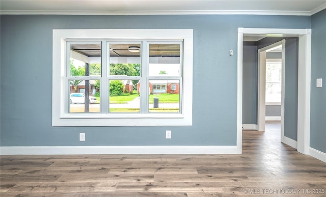 2532 E 4th St, Tulsa, OK 74104 - spare room featuring healthy amount of natural light, ornamental molding, and wood finished floors