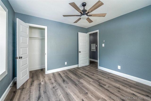 2532 E 4th St, Tulsa, OK 74104 - unfurnished bedroom featuring wood finished floors, a closet, and a ceiling fan