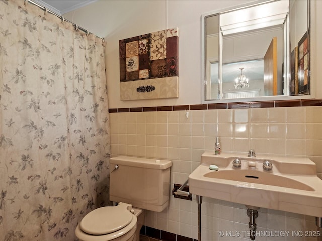 320 E 7th St, Pawhuska, OK 74056 - bathroom with tile walls, curtained shower, and a wainscoted wall