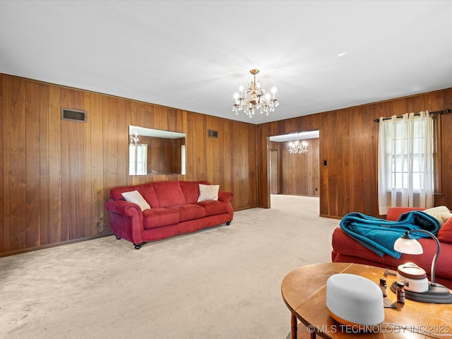 320 E 7th St, Pawhuska, OK 74056 - carpeted living room with a chandelier and wood walls