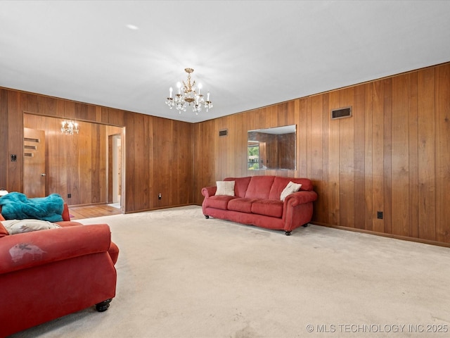 320 E 7th St, Pawhuska, OK 74056 - carpeted living area with a chandelier and wooden walls