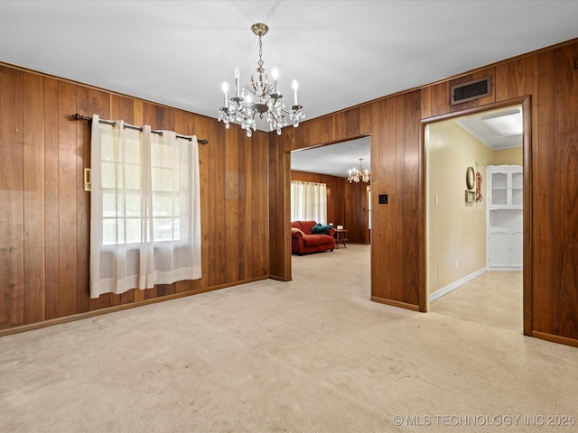 320 E 7th St, Pawhuska, OK 74056 - empty room with a chandelier, wood walls, and carpet