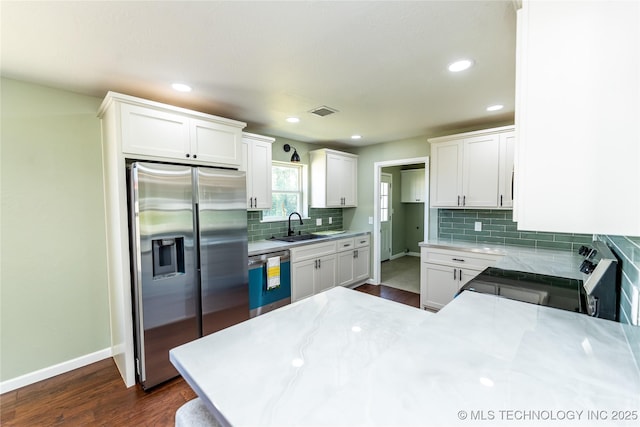 410 Denver St, Pawnee, OK 74058 - kitchen with stainless steel built in fridge, stove, dishwasher, tasteful backsplash, and white cabinets