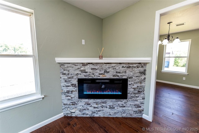 410 Denver St, Pawnee, OK 74058 - detailed view of wood finished floors, a chandelier, and a stone fireplace