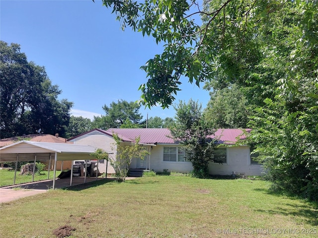 1713 E 10th St, Okmulgee, OK 74447 - view of front of home with a carport, a front yard, and a metal roof