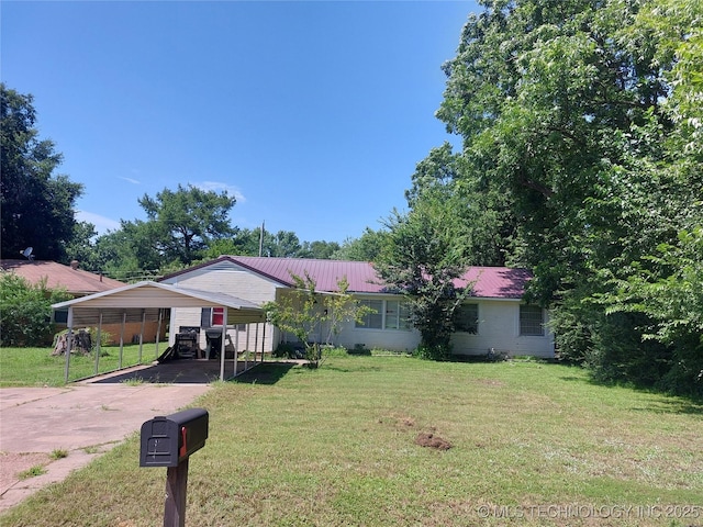 1713 E 10th St, Okmulgee, OK 74447 - view of front of home featuring driveway, a front lawn, and a metal roof