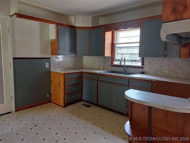 1713 E 10th St, Okmulgee, OK 74447 - kitchen with light flooring, light countertops, and tasteful backsplash