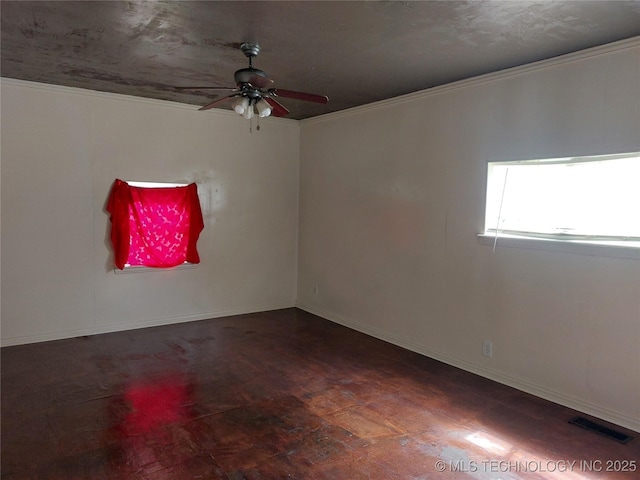 1713 E 10th St, Okmulgee, OK 74447 - unfurnished room featuring ceiling fan, wood finished floors, and crown molding