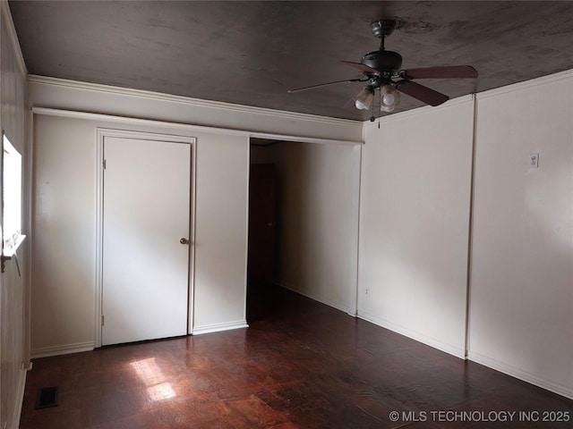 1713 E 10th St, Okmulgee, OK 74447 - unfurnished bedroom featuring wood finished floors and ceiling fan