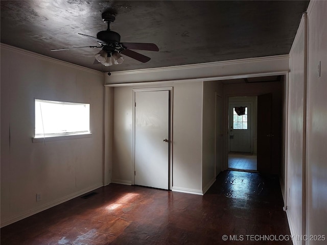 1713 E 10th St, Okmulgee, OK 74447 - unfurnished bedroom with dark wood-style flooring, ornamental molding, and a ceiling fan