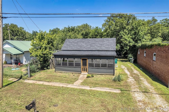 511 S Maple St, Sapulpa, OK 74066 - bungalow-style home with a sunroom, roof with shingles, a front yard, and driveway