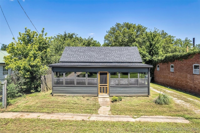 511 S Maple St, Sapulpa, OK 74066 - view of front of home featuring a shingled roof, a sunroom, and a front lawn