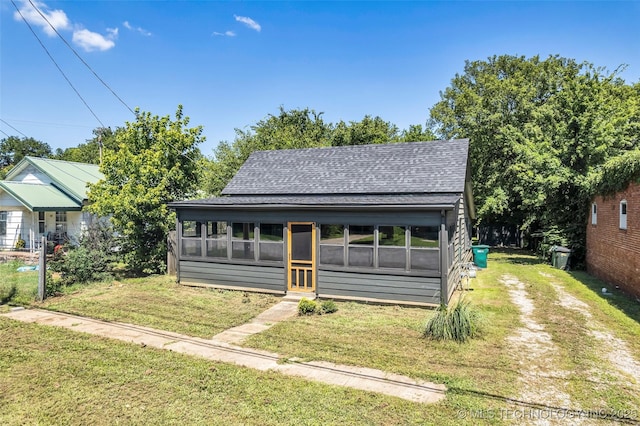 511 S Maple St, Sapulpa, OK 74066 - view of front of property featuring roof with shingles, a sunroom, a front yard, and driveway