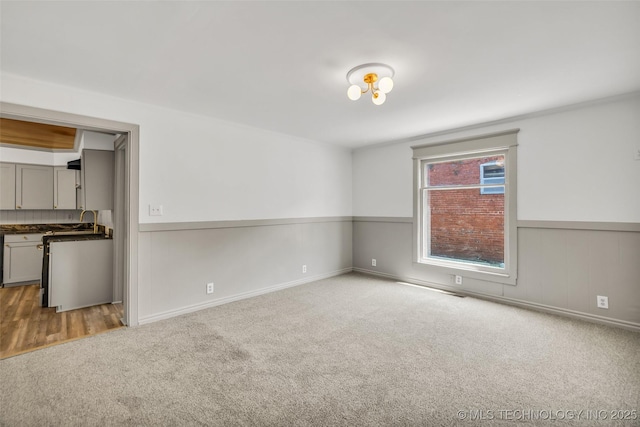 511 S Maple St, Sapulpa, OK 74066 - spare room with carpet flooring and a wainscoted wall