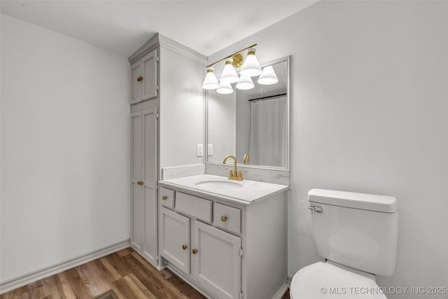 511 S Maple St, Sapulpa, OK 74066 - full bath with vanity, wood finished floors, and a chandelier