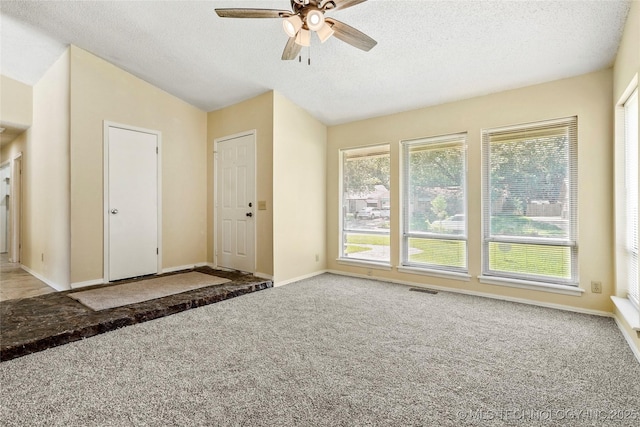 14127 E 24th Pl, Tulsa, OK 74134 - empty room with carpet floors, ceiling fan, a textured ceiling, and vaulted ceiling
