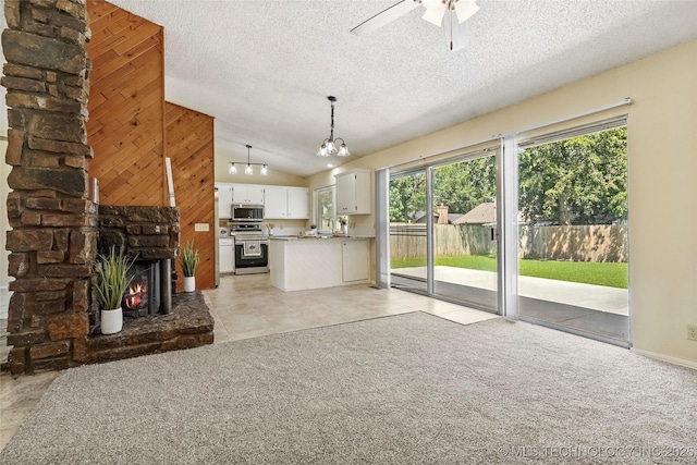 14127 E 24th Pl, Tulsa, OK 74134 - unfurnished living room featuring lofted ceiling, a textured ceiling, ceiling fan, a multi sided fireplace, and light carpet