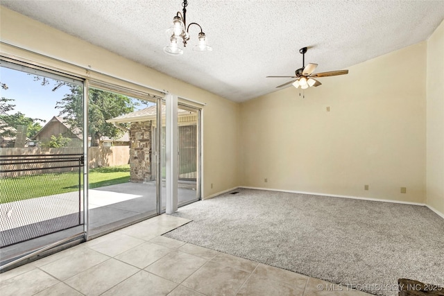 14127 E 24th Pl, Tulsa, OK 74134 - spare room with a ceiling fan, tile patterned floors, carpet flooring, a textured ceiling, and a chandelier