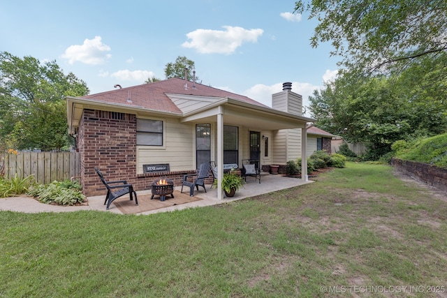 2244 W 45th St, Tulsa, OK 74107 - back of property featuring an outdoor fire pit, a chimney, a patio, and brick siding