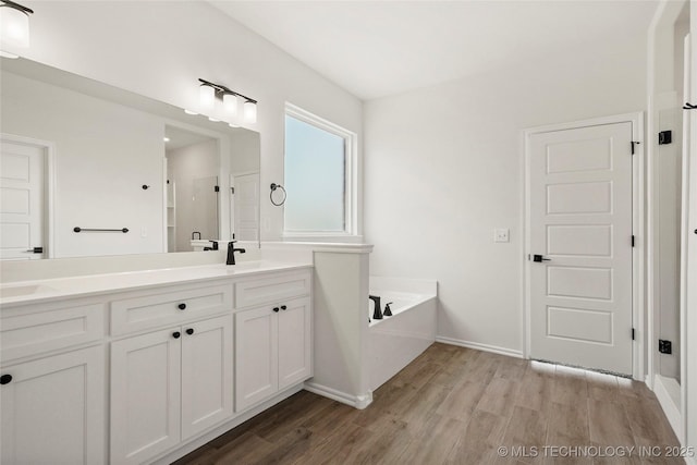 2916 S 8th St, Broken Arrow, OK 74012 - full bathroom with wood finished floors, double vanity, and a bath