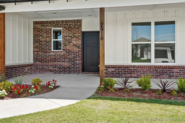 2916 S 8th St, Broken Arrow, OK 74012 - entrance to property with board and batten siding, brick siding, and a yard