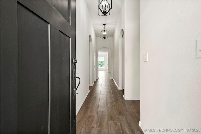 2916 S 8th St, Broken Arrow, OK 74012 - corridor with arched walkways, dark wood-style floors, and a chandelier