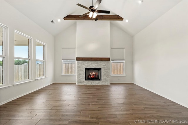 2916 S 8th St, Broken Arrow, OK 74012 - unfurnished living room featuring dark wood-style floors, high vaulted ceiling, a ceiling fan, beam ceiling, and a stone fireplace