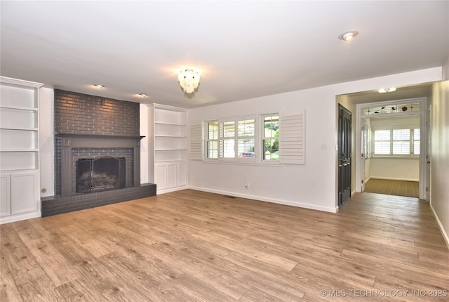 5654 S Marion Ave, Tulsa, OK 74135 - unfurnished living room featuring a fireplace and wood finished floors