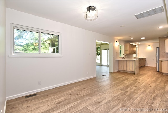 5654 S Marion Ave, Tulsa, OK 74135 - unfurnished living room featuring light wood finished floors and recessed lighting