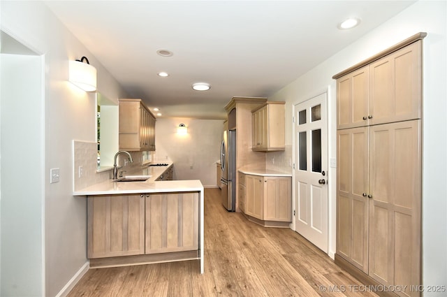 5654 S Marion Ave, Tulsa, OK 74135 - kitchen featuring freestanding refrigerator, light wood-type flooring, light countertops, recessed lighting, and decorative backsplash