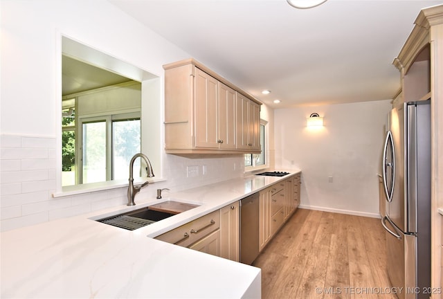 5654 S Marion Ave, Tulsa, OK 74135 - kitchen featuring stainless steel appliances, light wood finished floors, decorative backsplash, recessed lighting, and light stone countertops