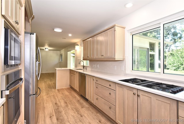 5654 S Marion Ave, Tulsa, OK 74135 - kitchen with appliances with stainless steel finishes, light brown cabinetry, light countertops, light wood-style flooring, and recessed lighting