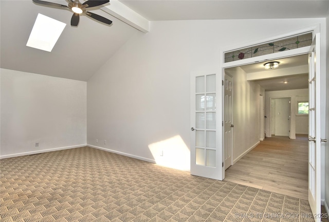 5654 S Marion Ave, Tulsa, OK 74135 - spare room featuring ceiling fan, light carpet, and a skylight